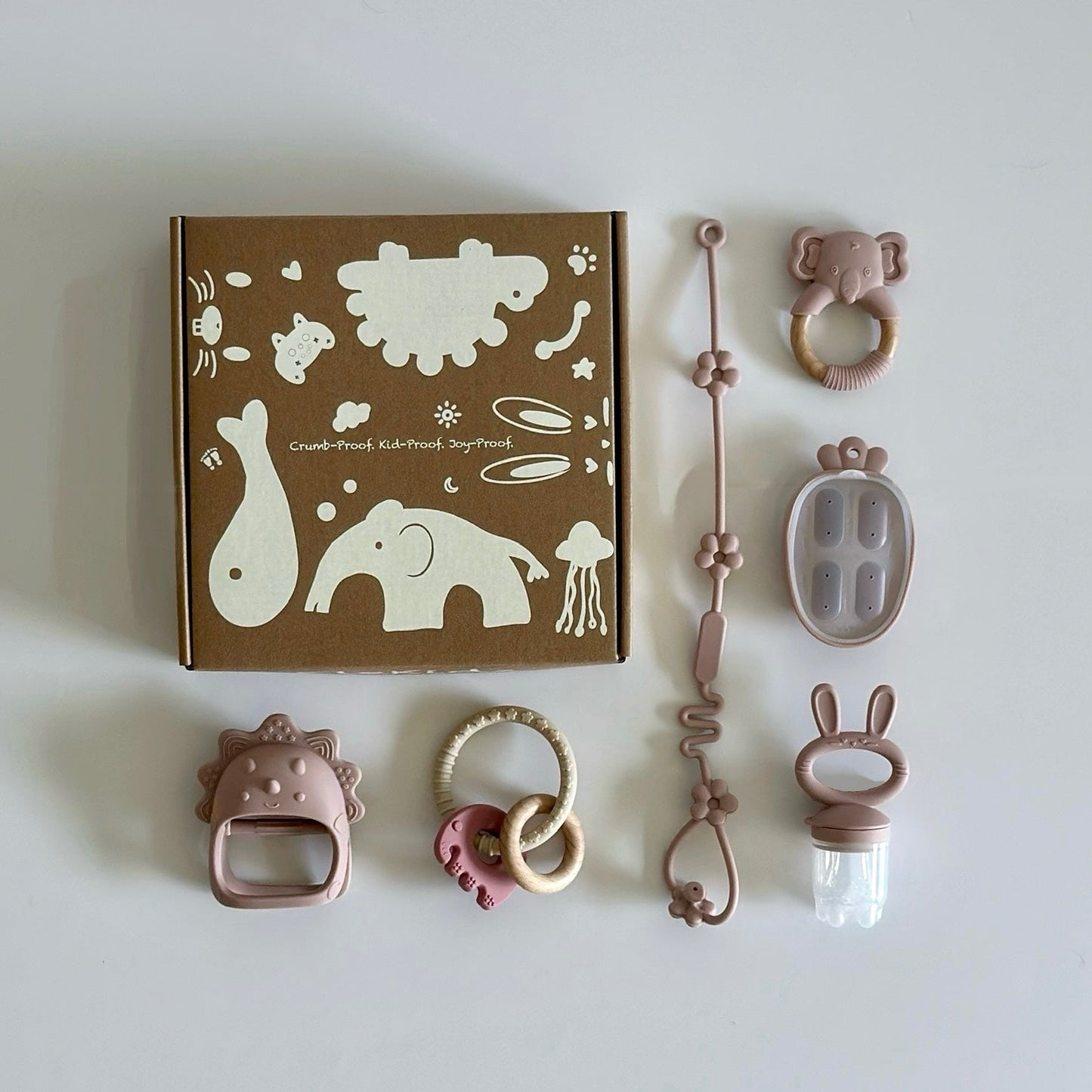 Six-piece baby teething set with BPA-free silicone toys including pacifier feeder, teether clip, rattles, and chewable rings, displayed with gift box.”