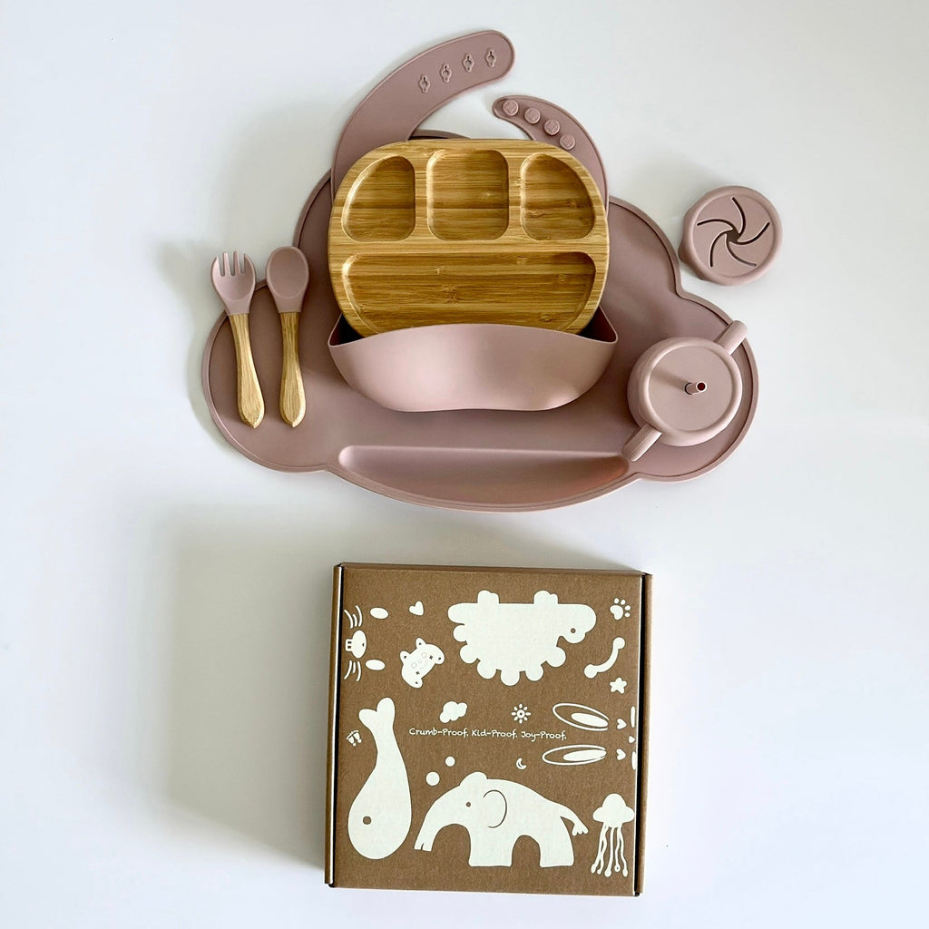 Silicone and bamboo baby feeding set with suction plate, bowl, utensils, adjustable bib, and toddler-safe packaging.”