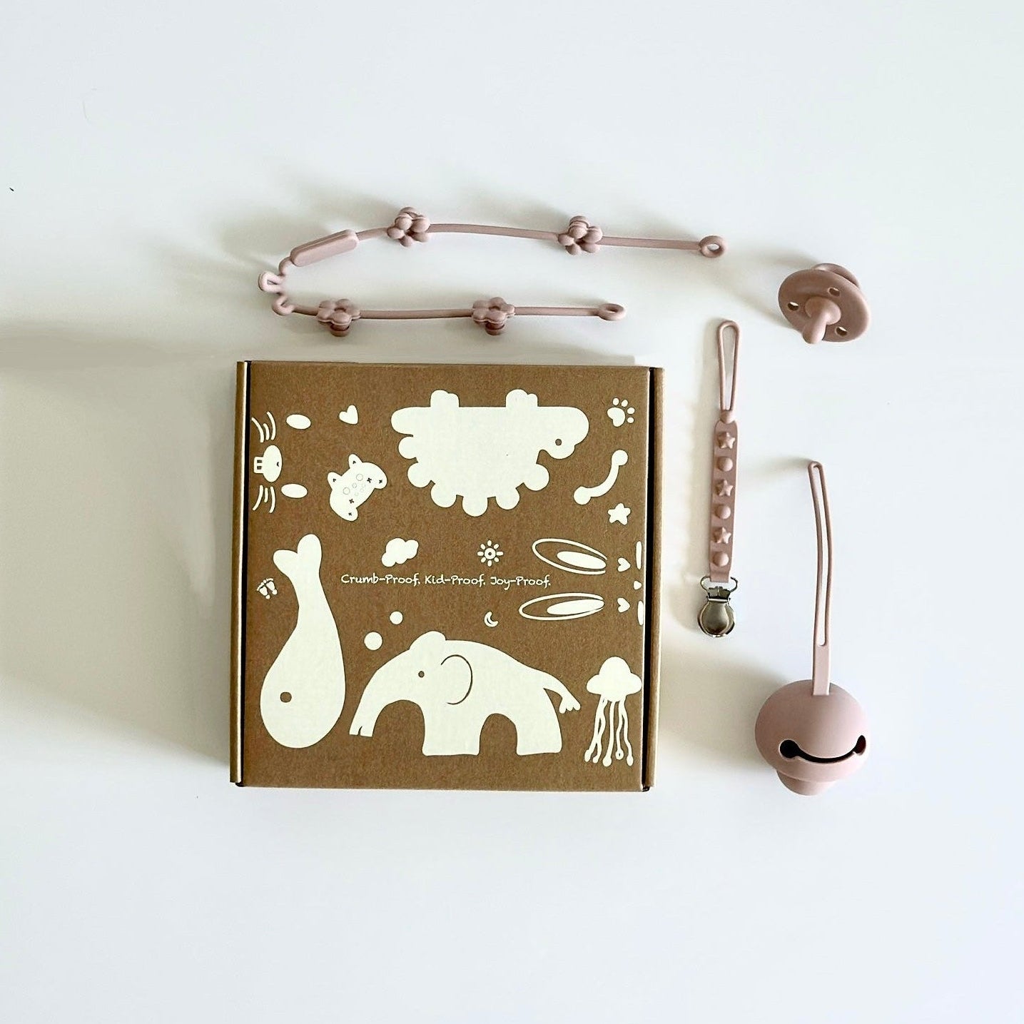 Elekidz silicone pacifier holder, pacifier clip, and toy straps set in dusty rose
	•	BPA-free silicone pacifier holder and toy straps with stainless steel clip
	•	Baby travel set with silicone pacifier holder, clip, and toy straps – dishwasher safe
