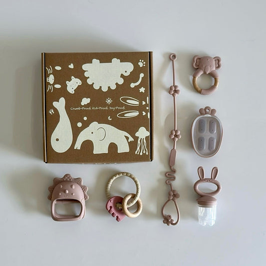 Six-piece baby teething set with BPA-free silicone toys including pacifier feeder, teether clip, rattles, and chewable rings, displayed with gift box.”
