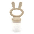 “Beige baby fruit feeder with bunny handle, made of BPA-free silicone and food-grade material”