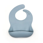 
The EleBib – Dusty Blue silicone baby bib with adjustable neck and deep food catcher pocket, BPA-free and waterproof